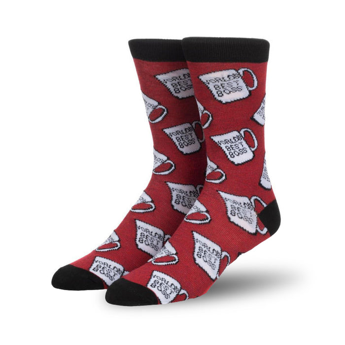 Pair of red crew socks featuring a repeating pattern of white mugs that say 'World's Best Boss'. Black cuff.