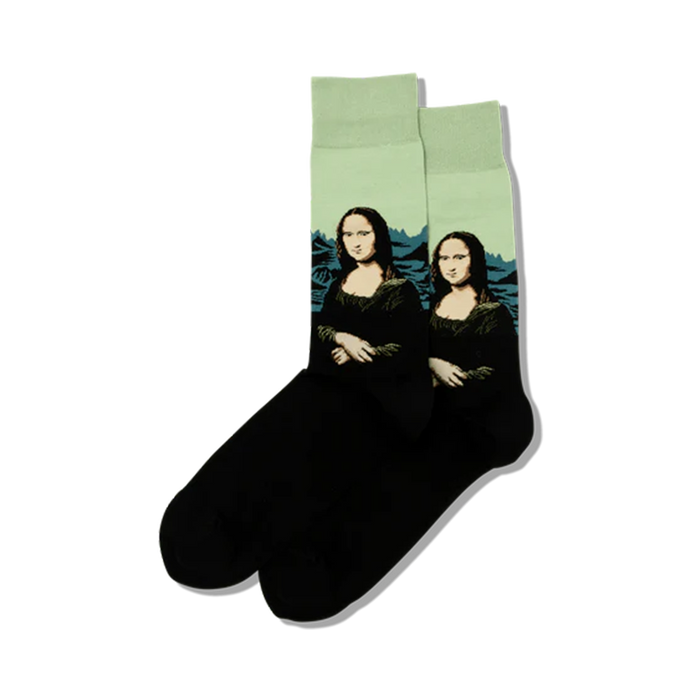 Lifestyle shot showing a pair of black crew socks with the Mona Lisa image on a mint green background.
