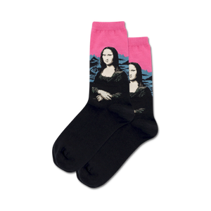Close-up of black crew socks with Mona Lisa art; the background is hot pink.