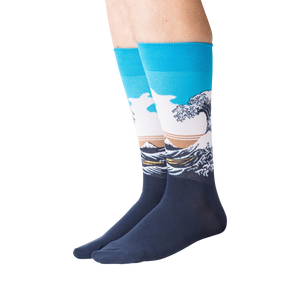 Lifestyle shot of model wearing Hokusai's Great Wave socks, showcasing the fit and design on legs.