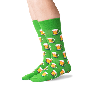 A pair of green socks with a pattern of beer mugs.