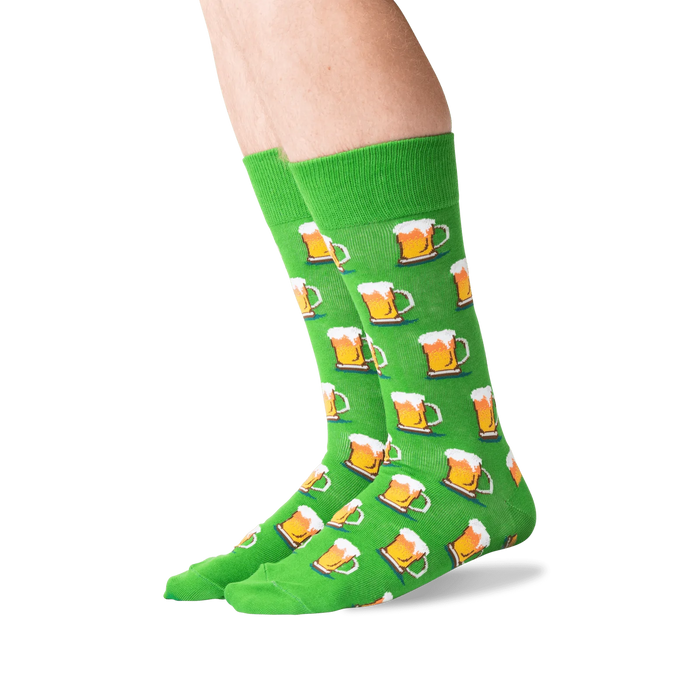 A pair of green socks with a pattern of beer mugs.