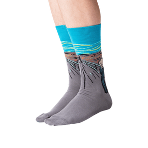 Flat lay of 'The Scream' socks in orange and teal showing full design.