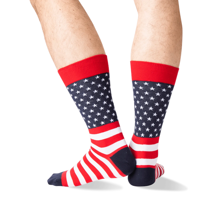 Rear view of the American Flag socks on a person's legs against a green background. The socks are red, white, and navy.