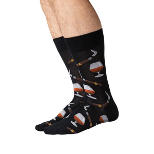 Lifestyle shot of a man's legs wearing the black Cognac and Cigars socks.