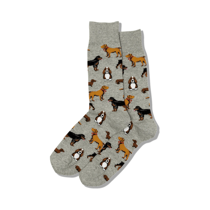 Pair of crew socks in light grey with repeating pattern of various dog breeds in brown and tan.