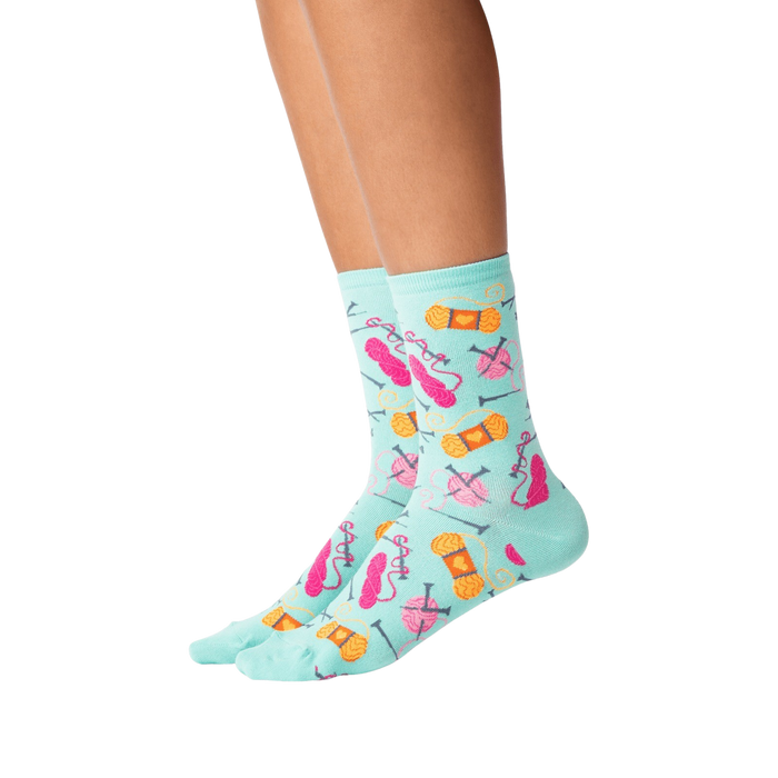 Lifestyle shot showing the socks on a person's legs against a black background.