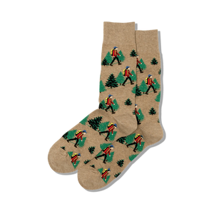 Pair of crew socks in beige featuring a repeating pattern of hikers and pine trees.  Perfect for outdoor enthusiasts!