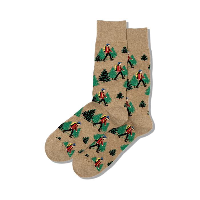 Pair of crew socks in beige featuring a repeating pattern of hikers and pine trees.  Perfect for outdoor enthusiasts!