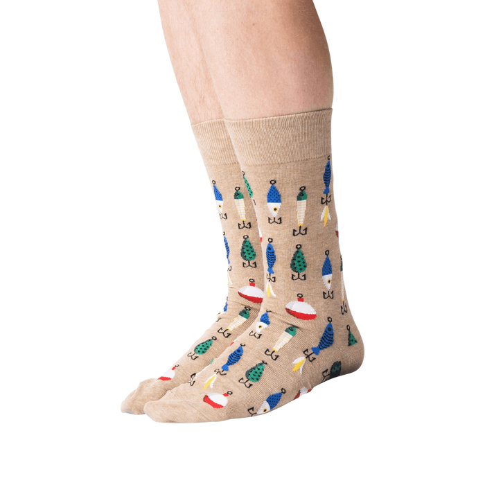 A pair of light brown calf-length socks with a pattern of fishing lures and bobbers in blue, green, orange, and white.
