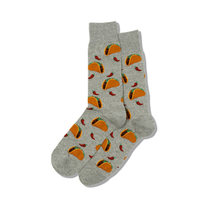Flat lay product shot showing a pair of gray crew socks with a taco and chili pepper print.