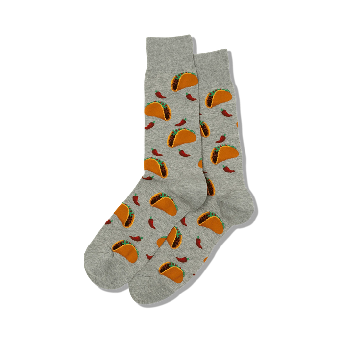 Flat lay product shot showing a pair of gray crew socks with a taco and chili pepper print.