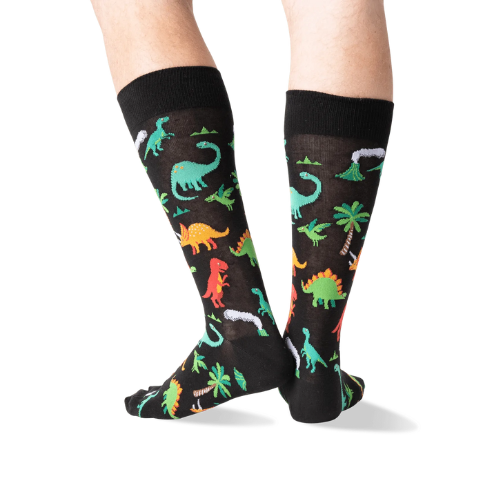 Back view of the dinosaur socks on a person's legs, highlighting the design details.