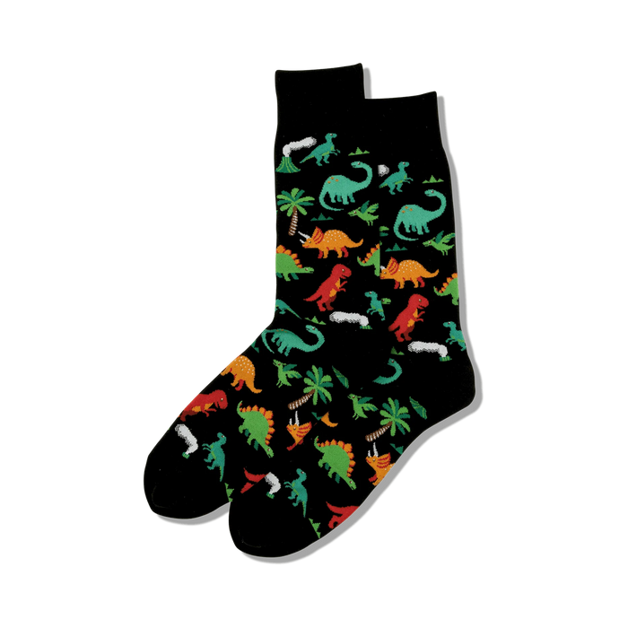 Pair of black crew socks with a fun pattern of colorful dinosaurs, palm trees, and volcanoes.