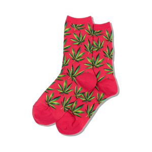 Pair of women's crew socks in pink and green, featuring a repeating marijuana leaf pattern.