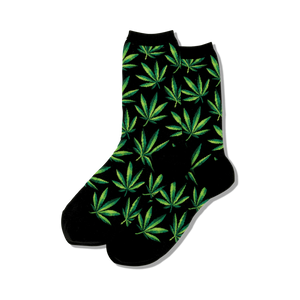 Close-up view of black crew socks with green marijuana leaf pattern.