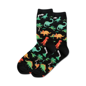 Pair of black crew socks with a fun pattern of colorful dinosaurs, palm trees, and volcanoes.