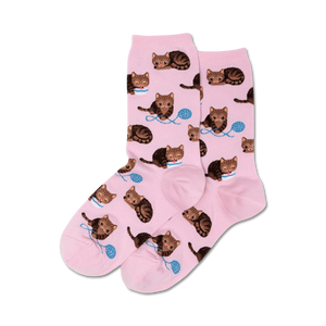 Pink crew socks with a repeating pattern of brown cats and yarn; shown as a pair.