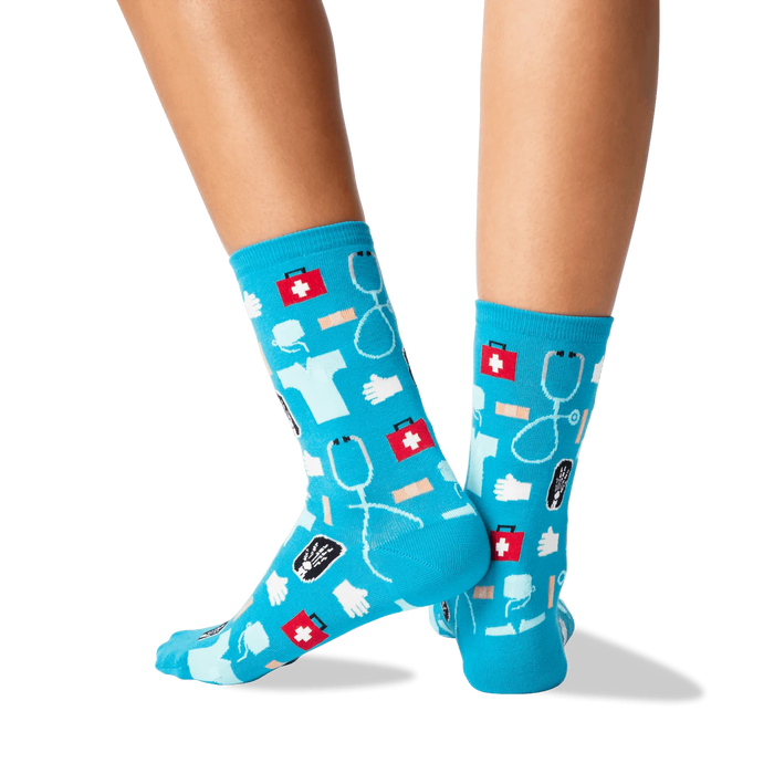 A pair of blue socks with a pattern of red first aid kits, white stethoscopes, and blue surgical gloves.