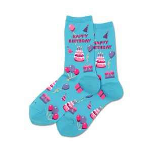 Pair of light blue crew socks with a 'Happy Birthday' design. Features pink and white pixelated cakes, balloons, and presents.