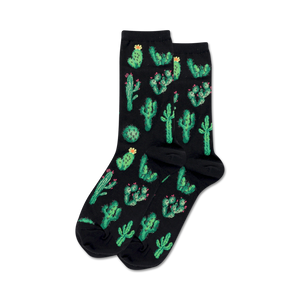 Pair of crew socks on black background.  Black socks feature a fun all-over print of green cacti with pink flowers.