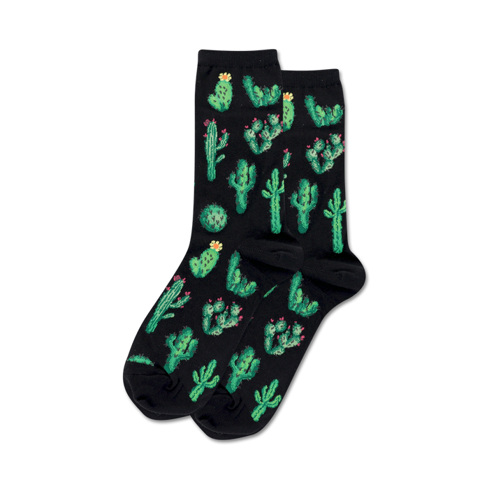 Pair of crew socks on black background.  Black socks feature a fun all-over print of green cacti with pink flowers.
