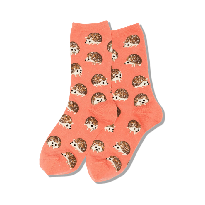 Pair of coral crew socks featuring an all-over print of brown hedgehogs.