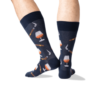 Lifestyle shot of a man's legs wearing the navy Cognac and Cigars socks.