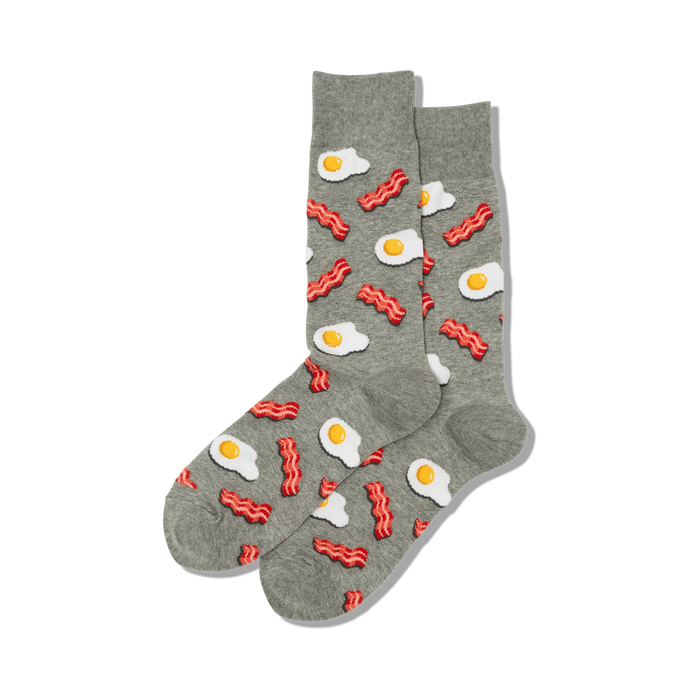Pair of grey crew socks with a fun pattern of fried eggs and bacon. A playful and quirky design for breakfast lovers! }}