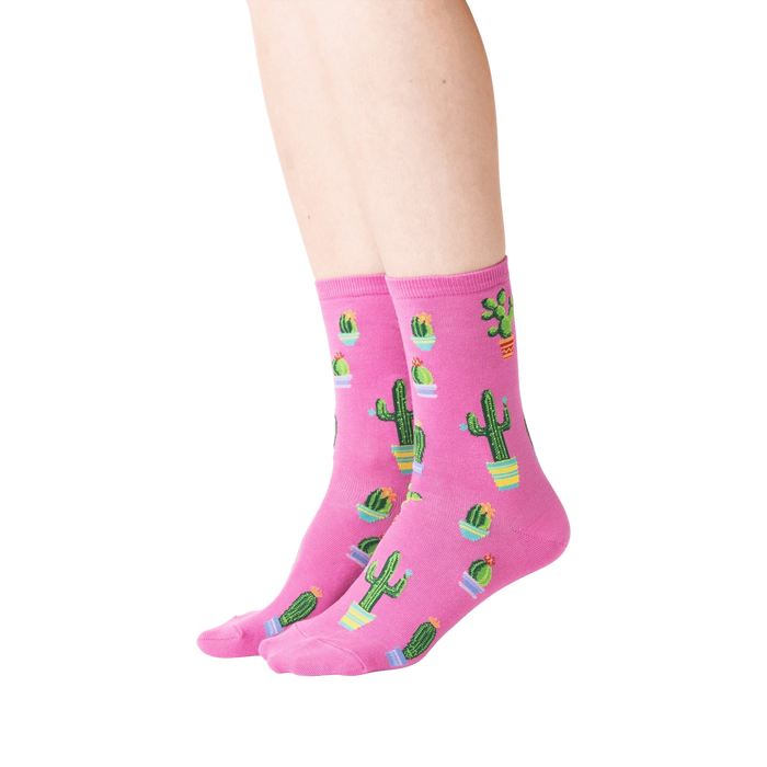 A pair of pink socks with a pattern of cacti in pots.