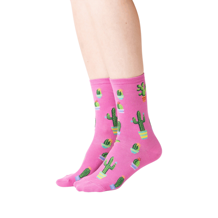 Lifestyle shot showing a model wearing the pink Potted Cactus socks.