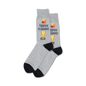 Pair of crew socks; grey and navy options; feature gold trophy and 'Trophy Husband' text.