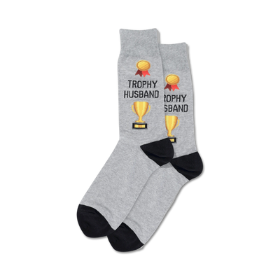 Pair of crew socks; grey and navy options; feature gold trophy and 'Trophy Husband' text.