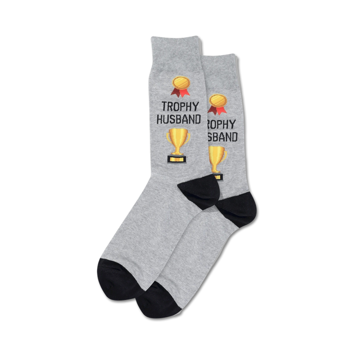 Pair of crew socks; grey and navy options; feature gold trophy and 'Trophy Husband' text.