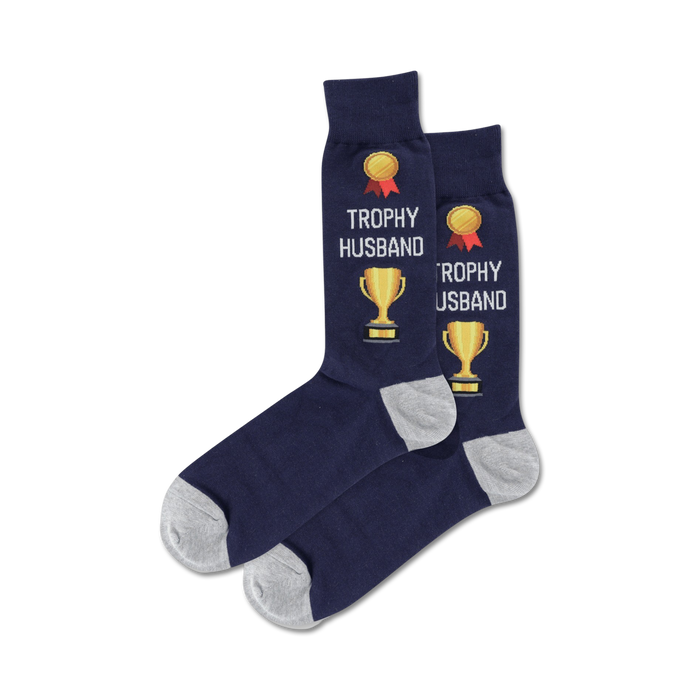 Lifestyle flatlay image showing a pair of navy 'Trophy Husband' socks.