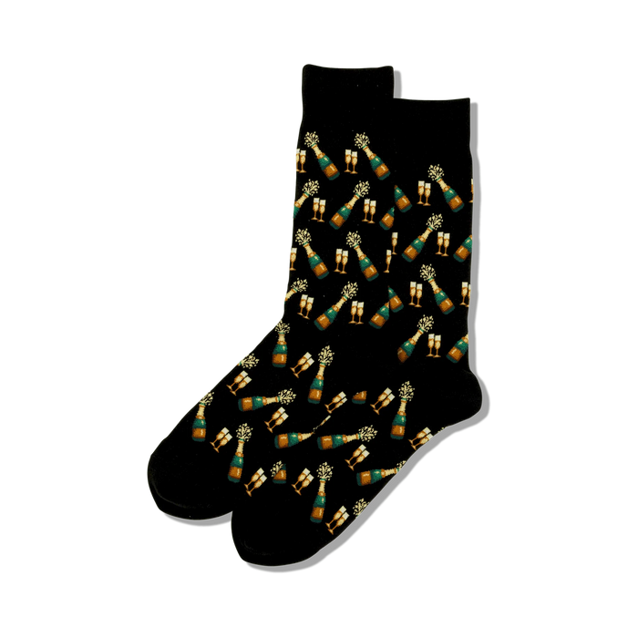 A pair of black crew socks featuring a repeating pattern of gold champagne bottles popping with green celebratory bursts and gold champagne glasses. }}