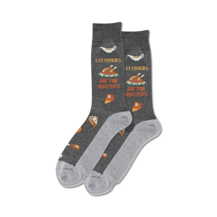 A pair of dark gray crew socks with a Thanksgiving theme. The socks feature images of turkey, pie, and gravy, along with the text 'Leftovers Are For Quitters'. }}