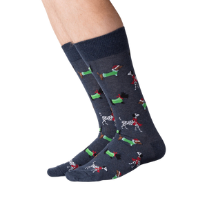 A pair of blue socks with a pattern of cartoon dachshunds wearing Santa hats and scarves.