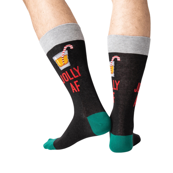 Back view of a person wearing black 'Jolly AF' socks; shows off the full design on the back of the socks.