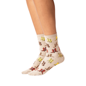 Lifestyle shot showing the socks on a person's legs. The socks are beige with a colorful cowboy boot print.