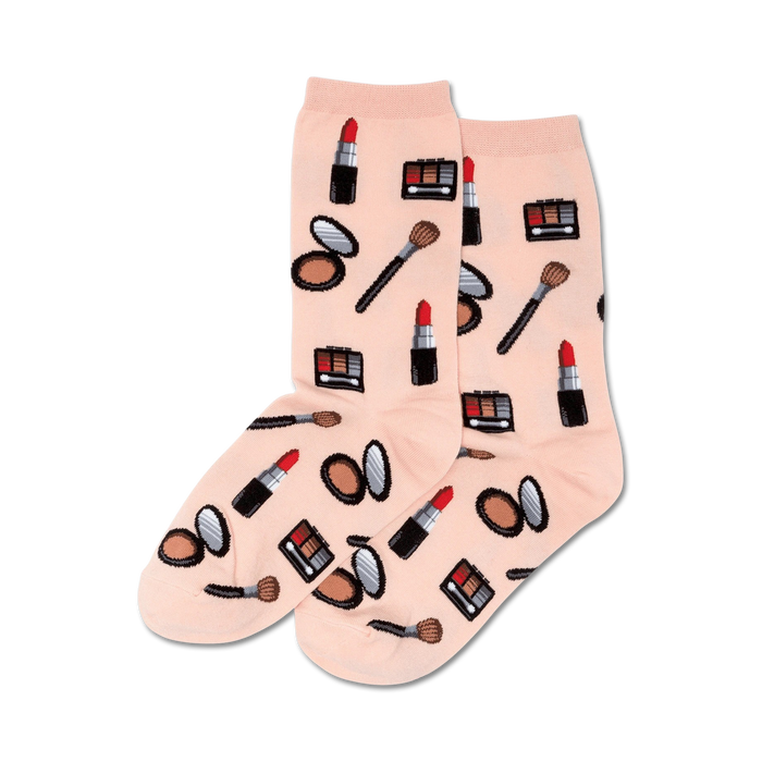 Pair of peach crew socks featuring a pattern of lipstick tubes, eyeshadow palettes, makeup brushes, and compact powder. }}