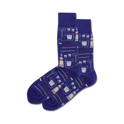Pair of purple crew socks with a whimsical dental design. The pattern includes toothbrushes, toothpaste, dental floss, and other dental tools.