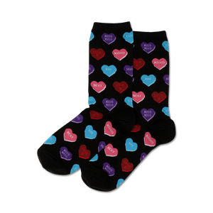 Pair of women's crew socks. Black background with colorful candy hearts that say 'Kiss Kiss', 'XOXO', etc.