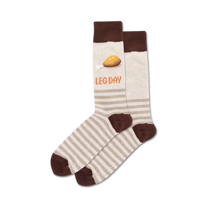 Pair of beige and brown striped crew socks. One sock features a cartoon chicken leg and the text 'LEG DAY'. }}