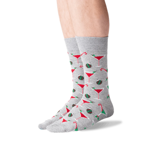 Lifestyle shot of male model wearing grey Christmas Cocktails socks.