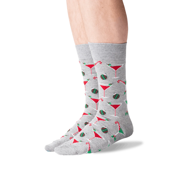 Lifestyle shot of male model wearing grey Christmas Cocktails socks.