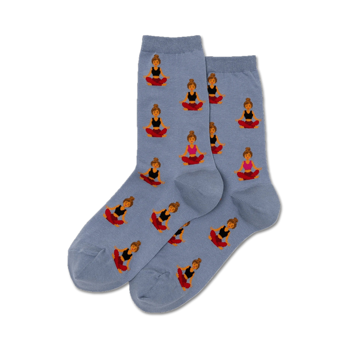 Pair of women's crew socks in dusty blue. The socks are adorned with a repeating pattern of illustrated women in yoga poses, wearing black and pink tops and red bottoms. }}