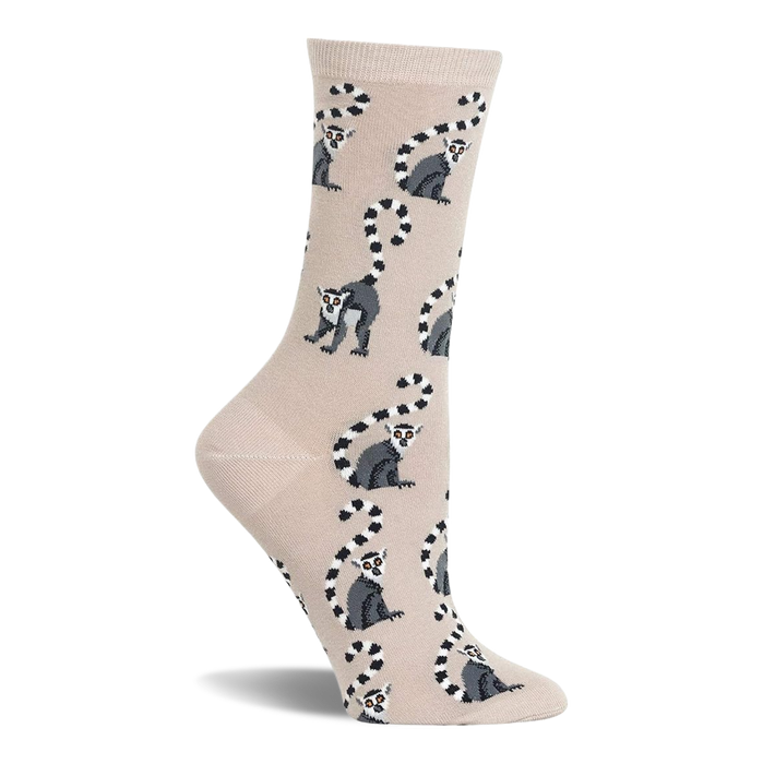 Beige crew socks with a repeating pattern of grey and white ring-tailed lemurs with black striped tails. }}