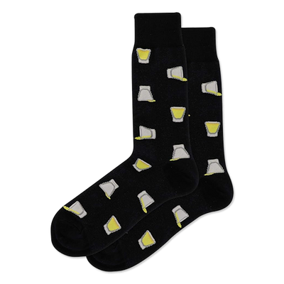 A pair of black crew socks with a scattered pattern of shot glasses, some filled with yellow liquid, others tilted and pouring.