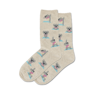 Close-up of beige crew socks featuring koalas practicing yoga.  The koalas have pastel accents.